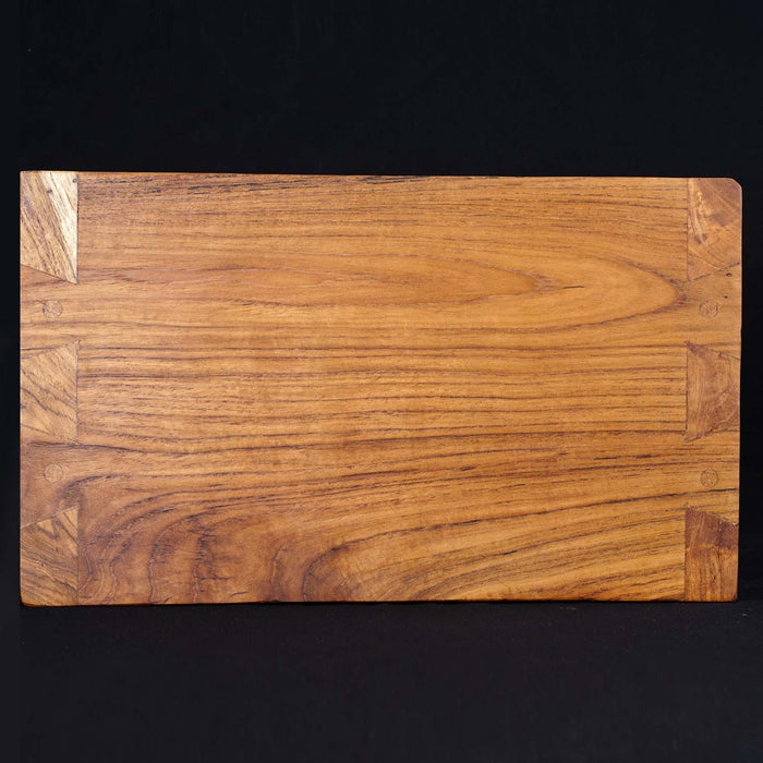 Top view of Rico & Plato wasabi teak serving platter displayed on a black background