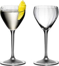 Set of two Riedel drink specific glassware Nick & Nora one with a white liquid and lemon peel inside and other is empty on a white background