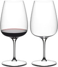 Two wine glasses, one filled with red wine, on a white background