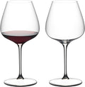 Two wine glasses, one filled with red wine, on a white background