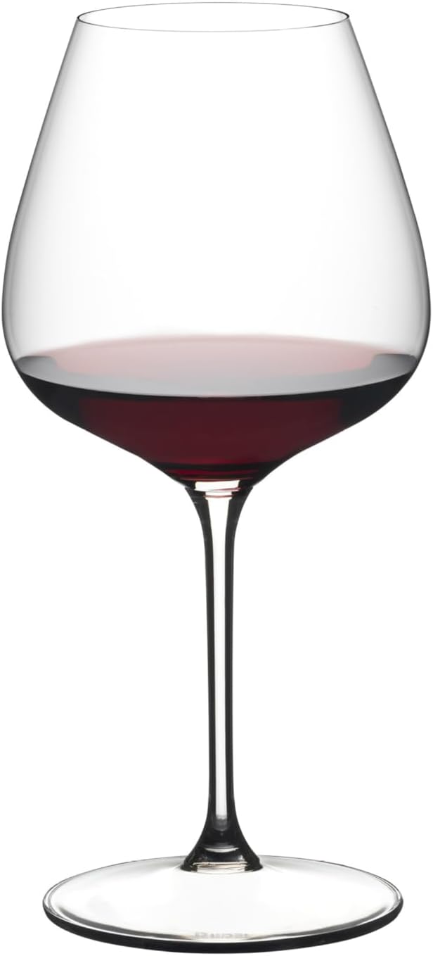 Wine glass filled with red wine on a white background