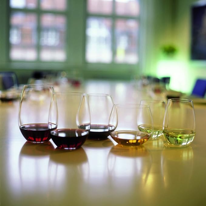 Six Riedel wine tumbler viognier chardonnay with red or white wine inside placed on a dining table