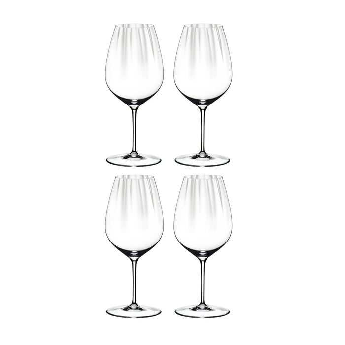 Set of four Riedel performance cabernet merlot glasses on a white background