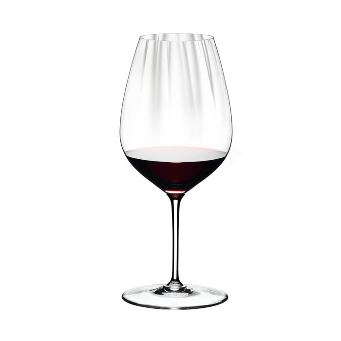 Riedel performance cabernet merlot glass with red wine on a white background