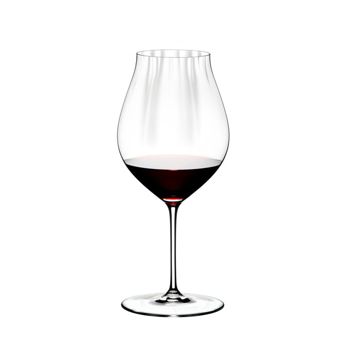 Riedel performance pinot noir glass with red wine inside on a white background