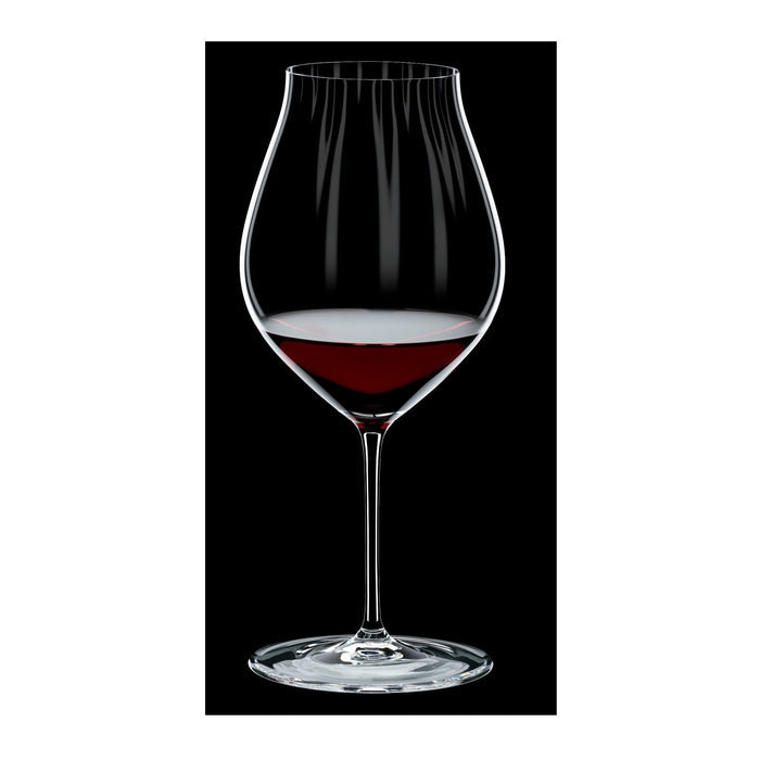 Riedel performance pinot noir glass with red wine inside on a black and white background