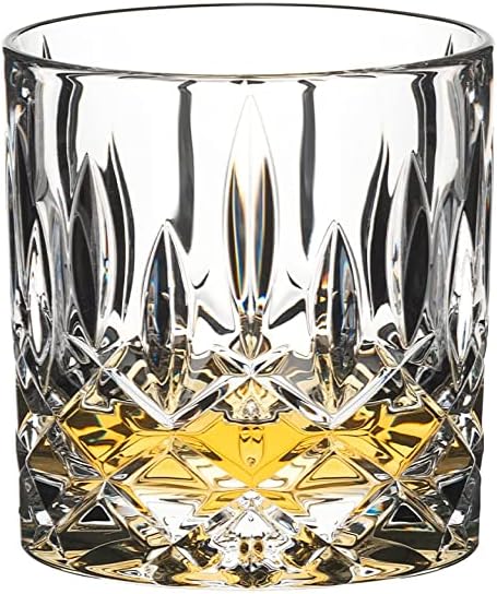 Riedel tumbler spey old fashioned with a brown liquid in the glass on a white background