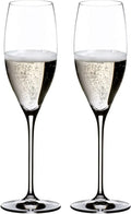 Two clear champagne flutes filled with sparkling champagne, shown side by side on a plain white background.