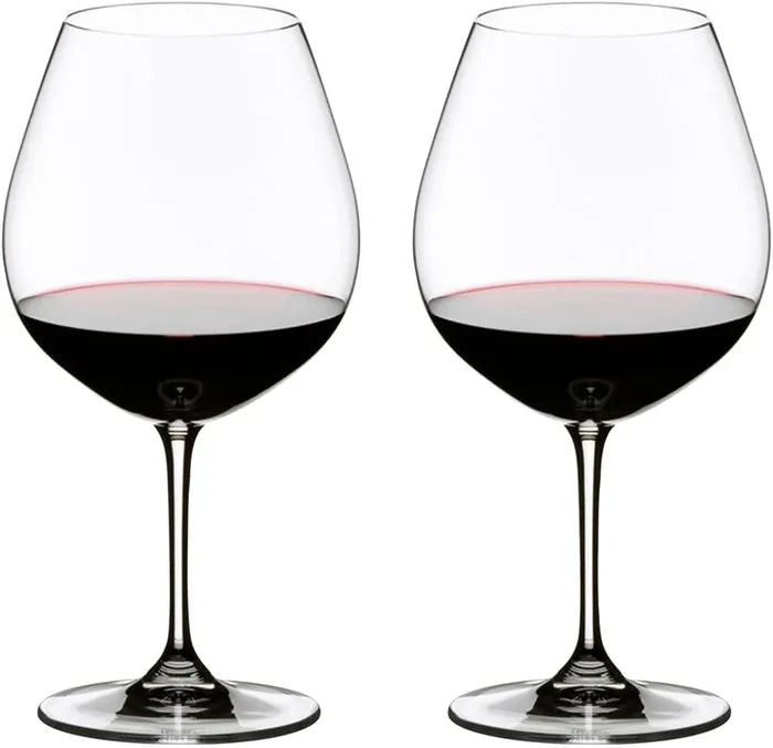 Two clear stemmed wine glasses filled with red wine, shown side by side on a plain white background.