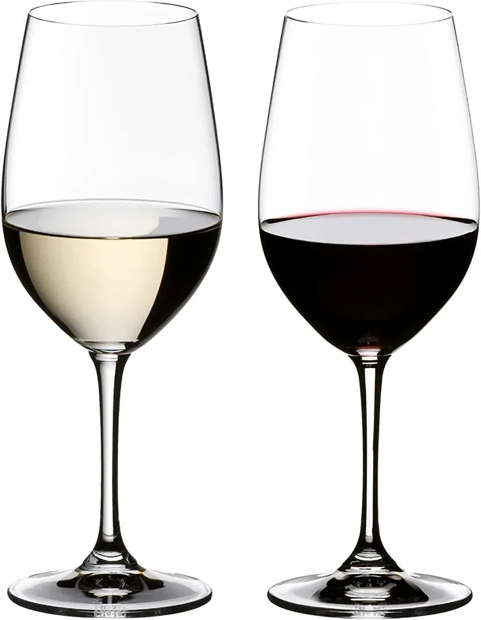 Two elegant wine glasses on a white background, one filled with white wine and the other with red wine.