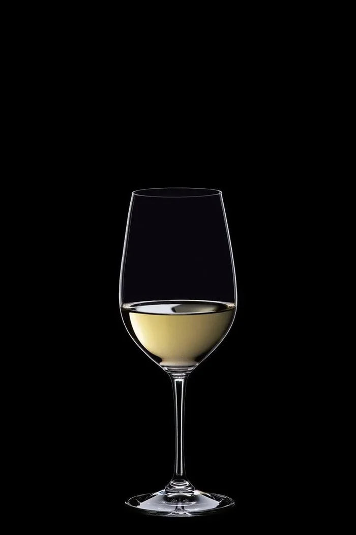 Glass of white wine on a black background