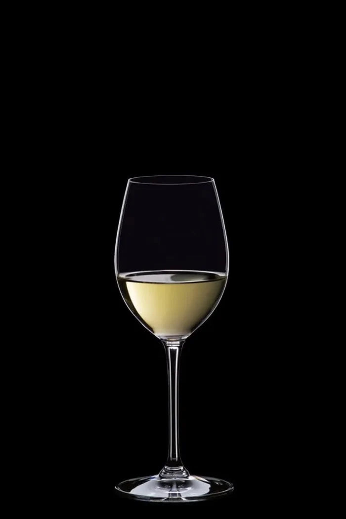 Wine glass with white wine on a black background