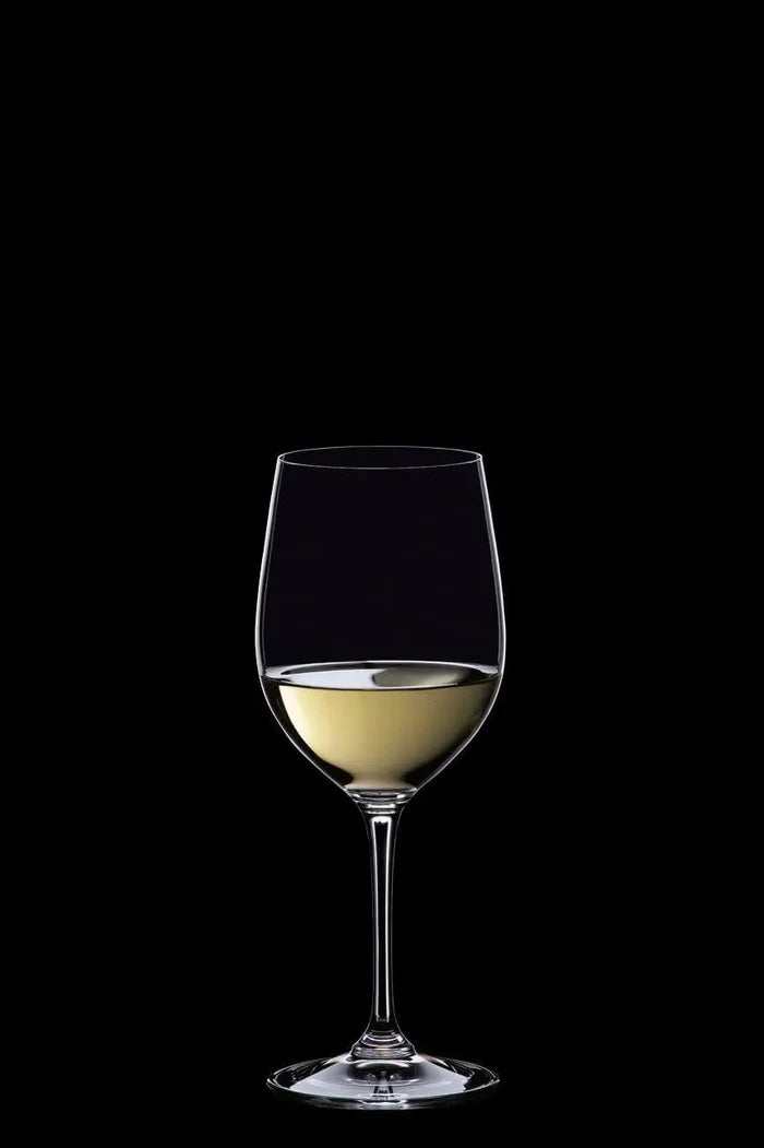 A clear wine glass partially filled with white wine, centered against a solid black background.