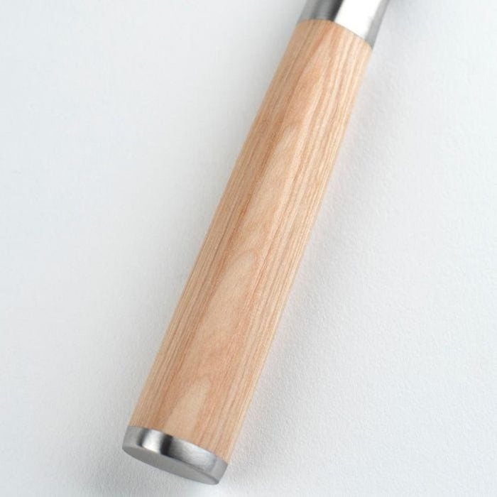 Close up of handle of Shun Classic Blonde Chef's Knife 6″ displayed on a white background