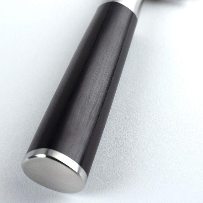 Close up of handle of Shun Classic Master Utility 6.5″ displayed on a white background