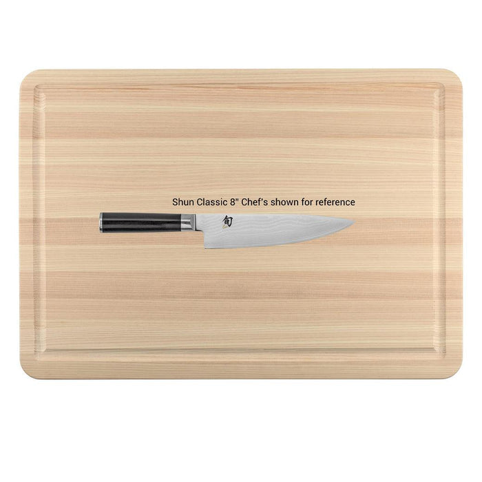 Top view of Shun Hinoki Cutting Board with knife on top displayed on a white background