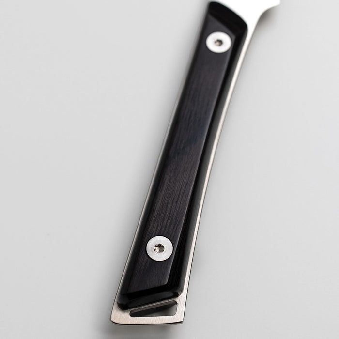 Close up of Shun paring knife ebony handle on a white background