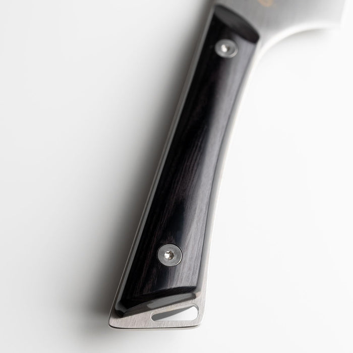Close up of the ebony handle of  Shun santoku knife on a white background