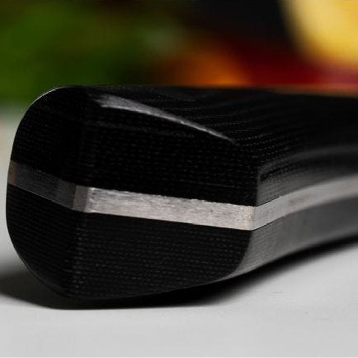 Close up of chef knife handle on a blurred background