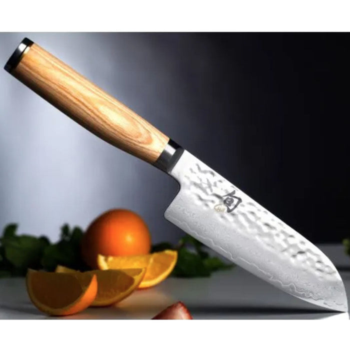 5.5 inch Shun santoku knife with blonde handle with sliced vegetables in the background