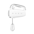 Front view of white hand mixer with whisk attachment on a white background, featuring the Smeg brand.