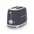 Dark gray Smeg toaster with silver accents on a white background
