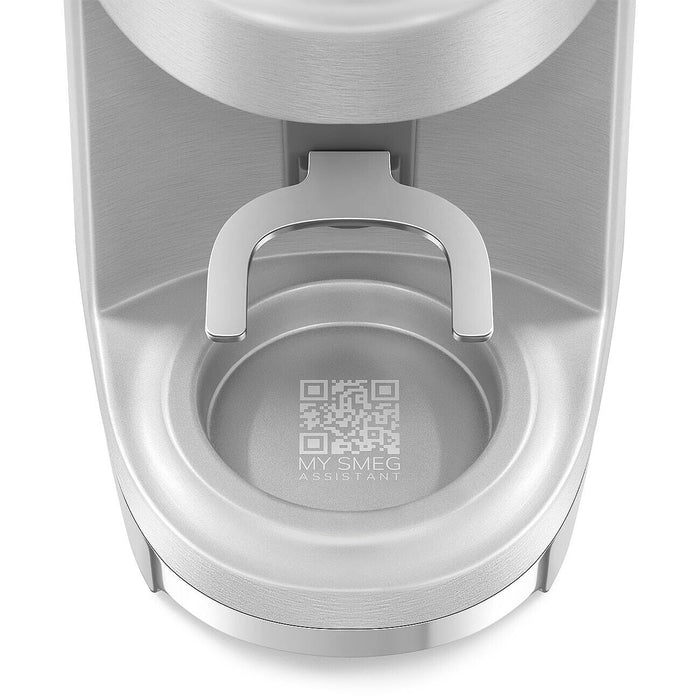 Close up of portafilter holder for a stainless steel Smeg retro style electric espresso coffee grinder on a white background