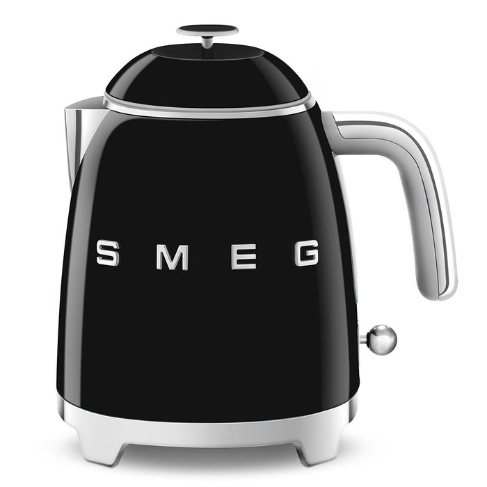 Front view of black Smeg 50s retro style electric mini kettle displayed on a white background