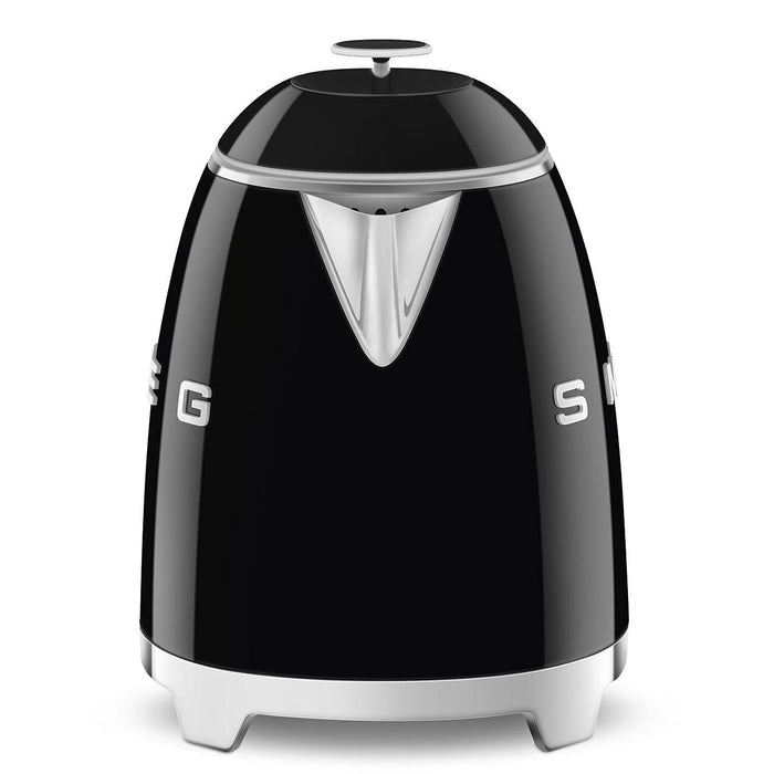 Side view of black Smeg 50s retro style electric mini kettle displayed on a white background