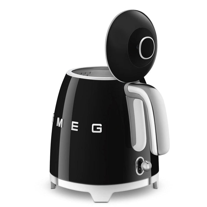 Black Smeg 50s retro style electric mini kettle with lid open displayed on a white background
