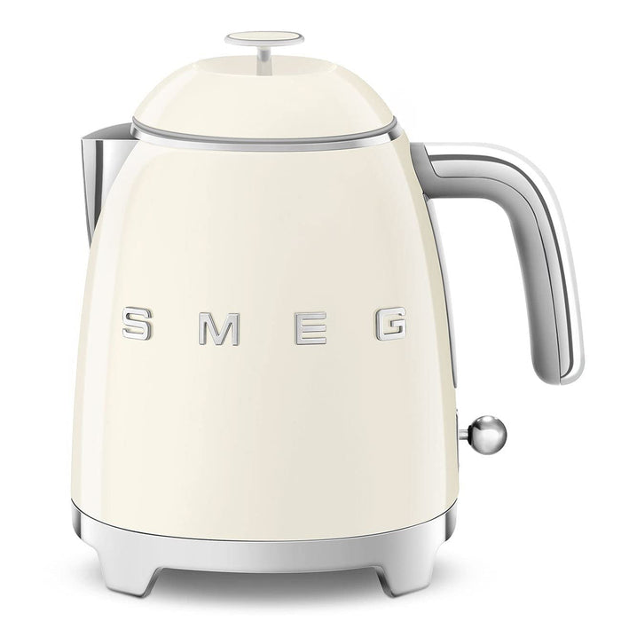 Front view of Smeg cream-colored kettle with metallic accents on a white background