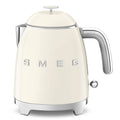Front view of Smeg cream-colored kettle with metallic accents on a white background