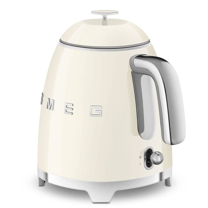 Smeg cream-colored kettle with metallic accents on a white background