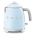 Front view of light blue kettle with SMEG logo on a white background