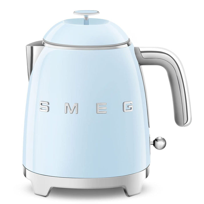 Front view of light blue kettle with SMEG logo on a white background