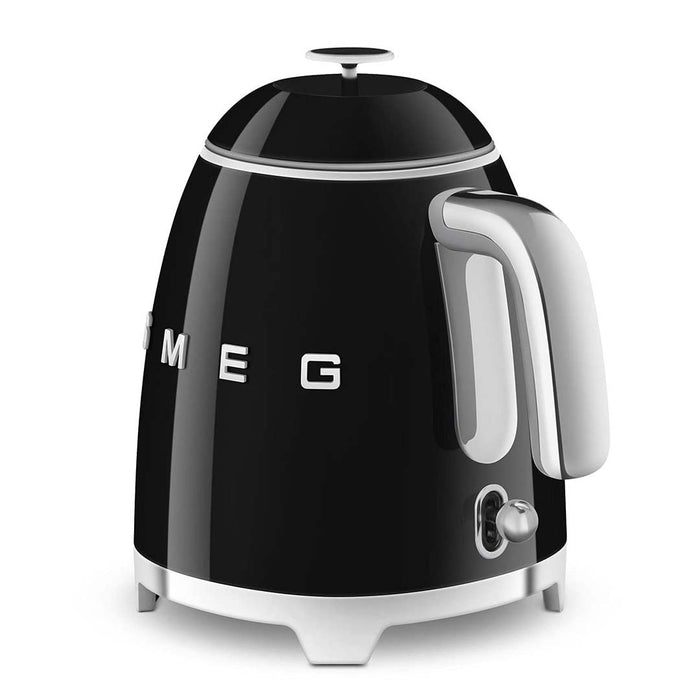 Black 1.7 liter Smeg 50s retro style electric mini kettle with power switch displayed on a white background
