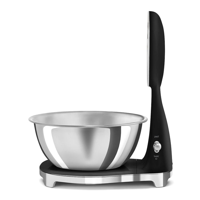 Side view of a black, silver Smeg retro style analog digital kitchen scale on a white background
