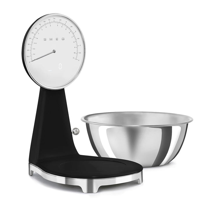 Black, silver Smeg retro style analog digital kitchen scale with silver bowl on the side on a white background