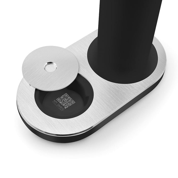 Metallic stand with circular base and black cylindrical component on a white background