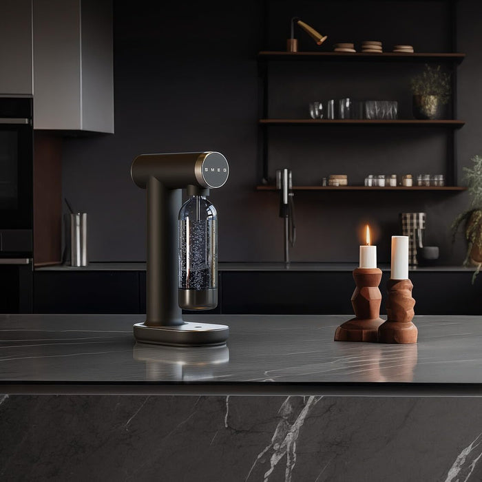 Modern kitchen with a black countertop and a sleek black soda maker with a clear bottle.