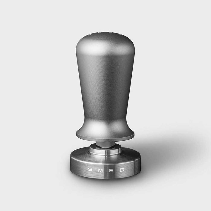 Stainless steel Smeg tamper on a white background