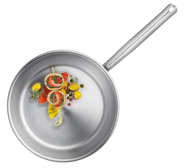 Stainless Steel frying pan with cooked peppers and veggies displayed on a white background