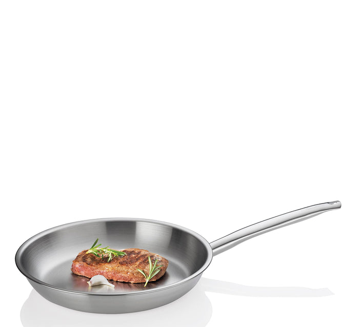 Stainless steel frying pan with a cooked steak and rosemary on a white background