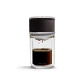 Glass coffee maker with black lid on a white background