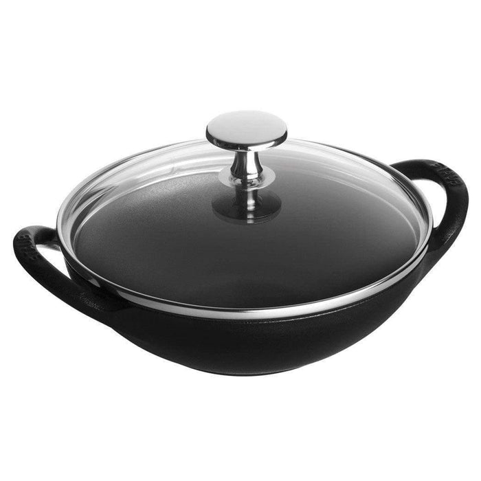 Matte black Staub Cast Iron 0.5-qt Baby Wok with glass lid displayed on a white background
