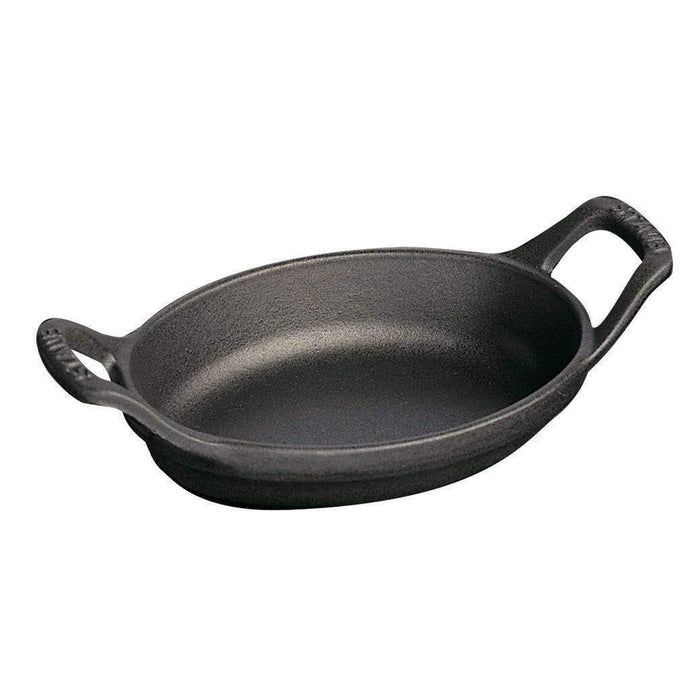 Matte black Staub Cast Iron 5.5″ x 3.8″ Mini Oval Gratin Baking Dish displayed on a white background