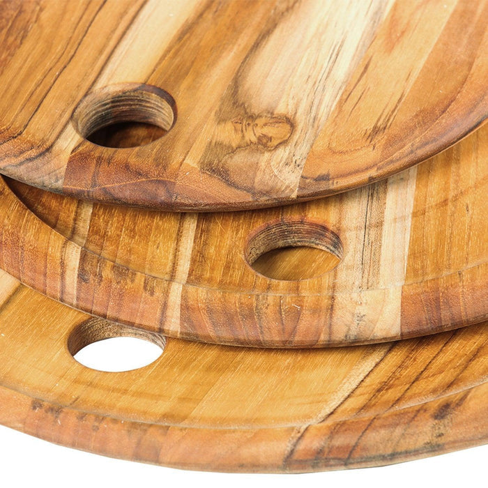 Close up of the holes on Teakhaus Lunar Boards, Set of 3 displayed as a stack that are meant for hanging