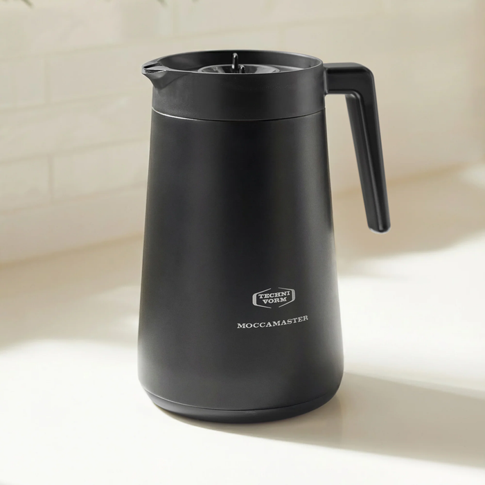 Black coffee pot with 'Technivorm' branding on a beige background