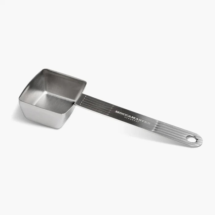Metal measuring scoop with handle on a white background