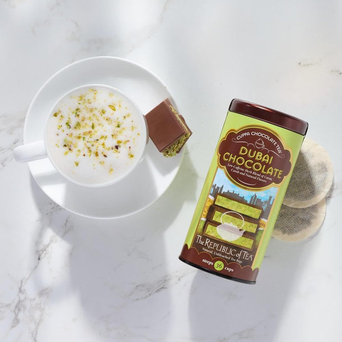 Dubai Chocolate tea canister with a cup of tea and a chocolate bar on a marble surface